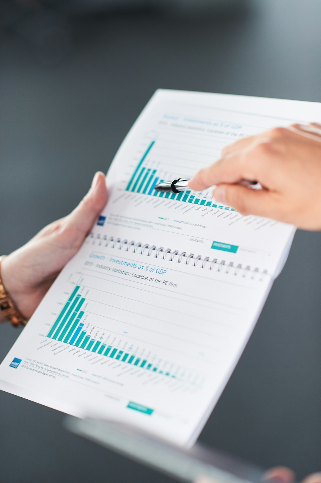 Services hands-pointing-at-data-charts-in-a-document-f-2q9g7movy