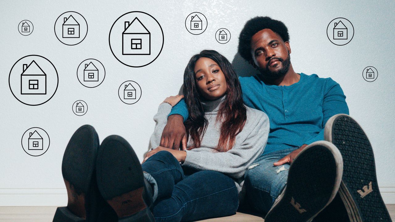 Home Couple sitting on the floor dreaming about new home ownership surrounded by house icons.